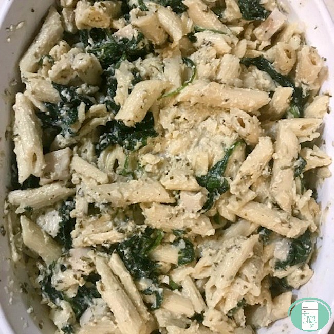 close up of chicken and spinach Alfredo bake in a casserole dish