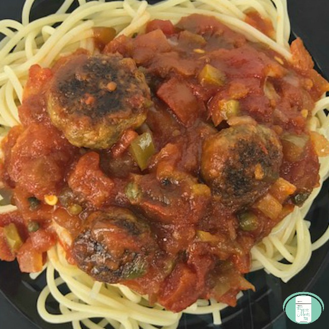 close up of spicy Italian sausage sauce on spaghetti