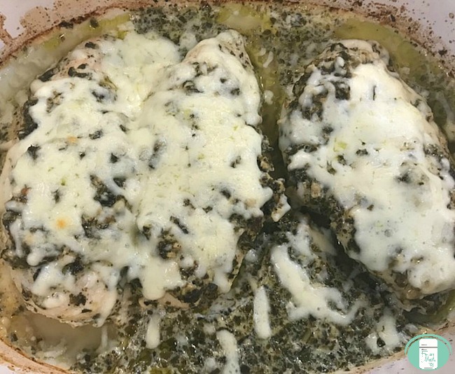 close up of lemon pesto chicken in the pan with cheese on top