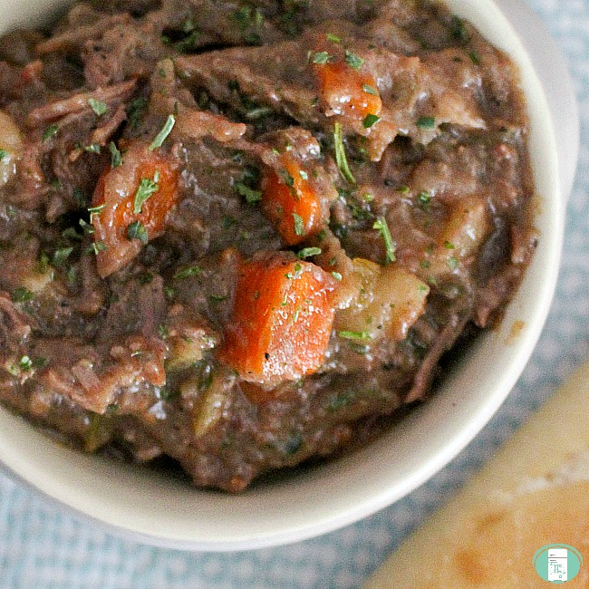 close up of rustic crockpot beef stew with meat and carrots