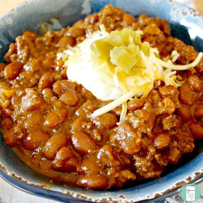 close up of BBQ baked beans with sour cream on top