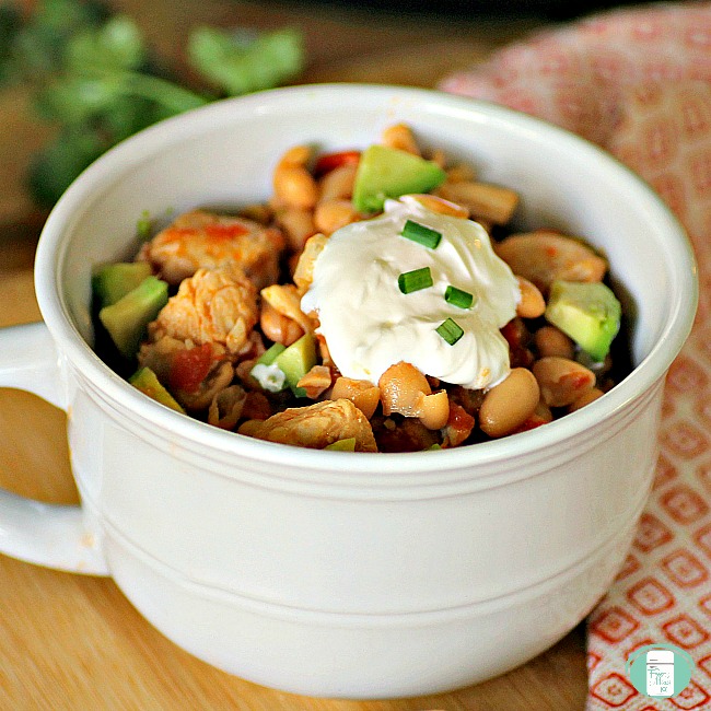 bowl of white chicken chili topped with sour cream