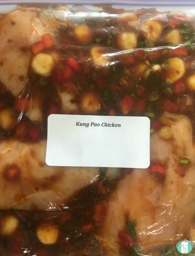 close up of kung pao chicken in a freezer bag with label