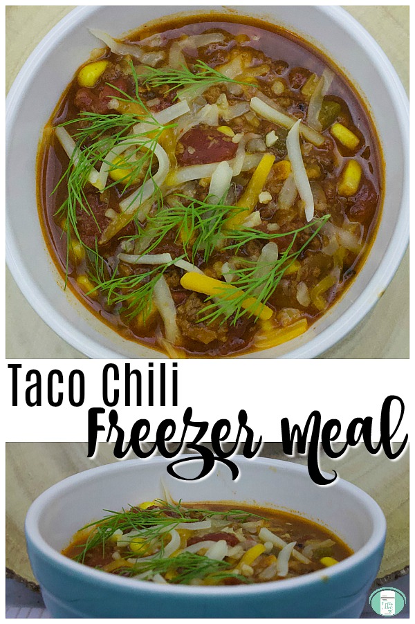 a blue bowl that's white on the inside is filled with corn, ground beef, tomatoes, red sauce that is topped with shredded cheese and green herbs with text that reads "Taco Chili Freezer Meal" #freezermeals101 #tacochili #makeaheadmeals #tacofreezermeal