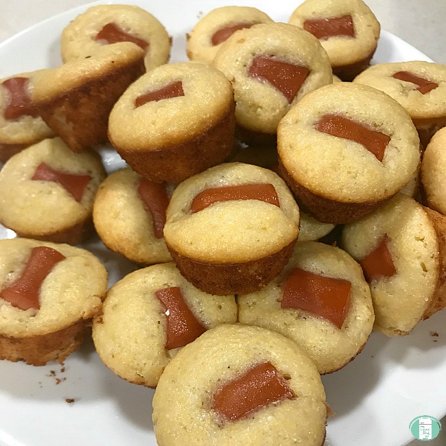 close up of corn dog mini muffins piled on a plate