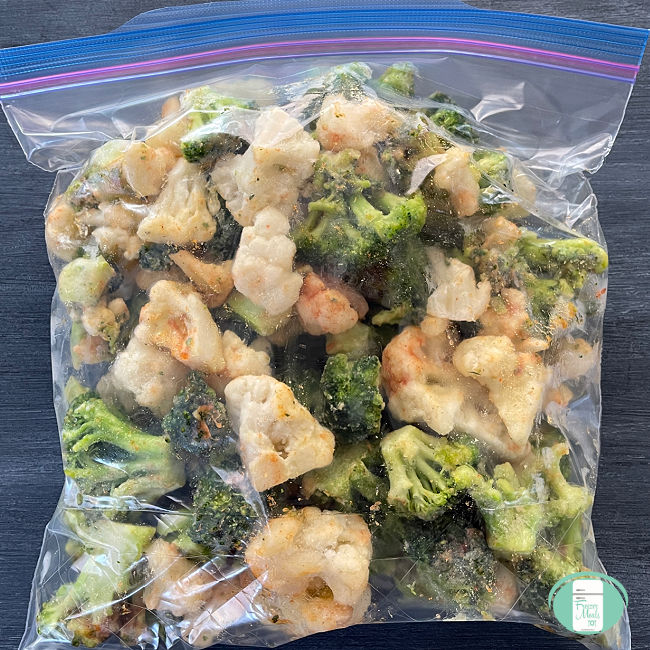 clear bag with raw cauliflower and broccoli in it