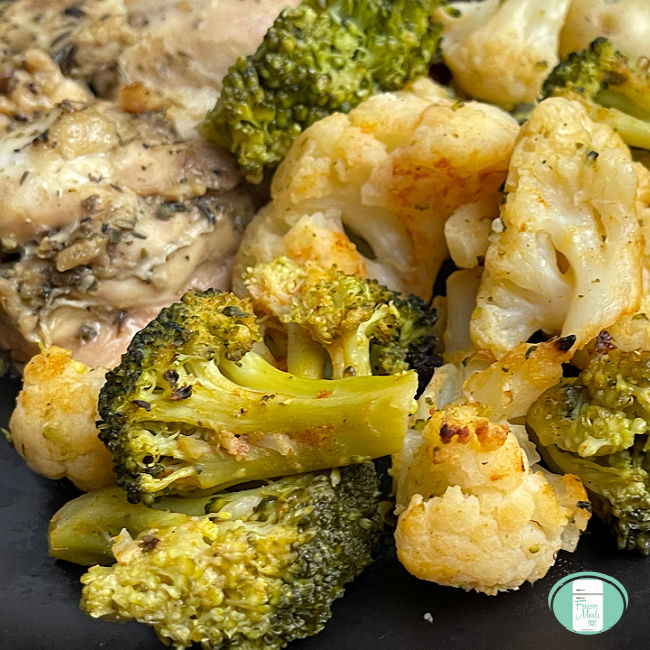 broccoli and cauliflower on a plate next to some chicken
