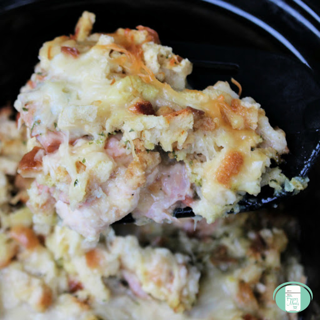 close up of chicken cordon bleu casserole in the crockpot being lifted with a fork