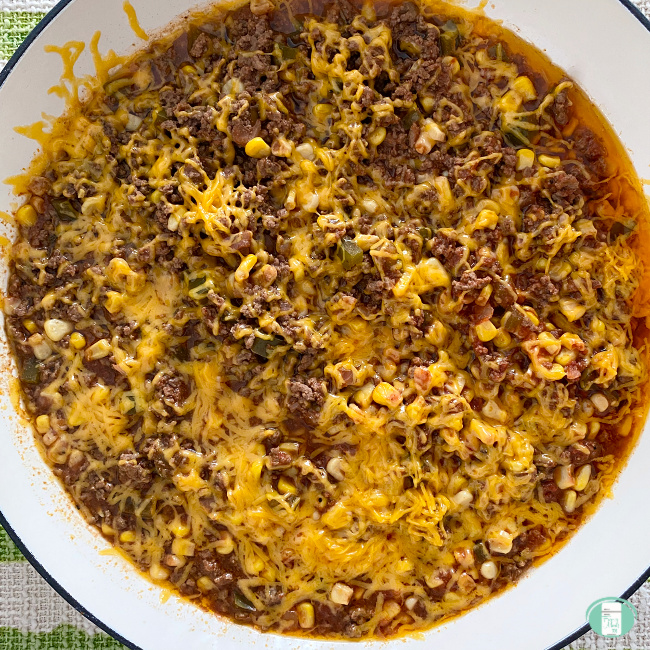 southern-style beef casserole in a bowl, topped with cheese