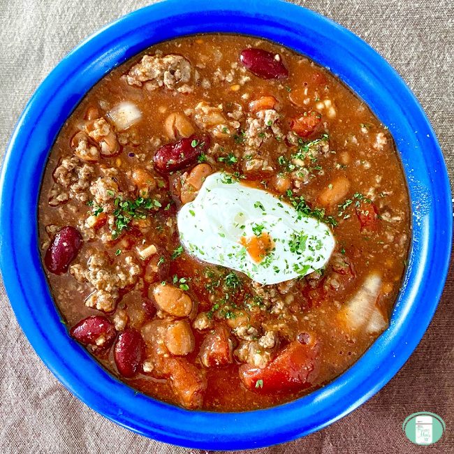 close up of freezer chili with a dollop of sour cream