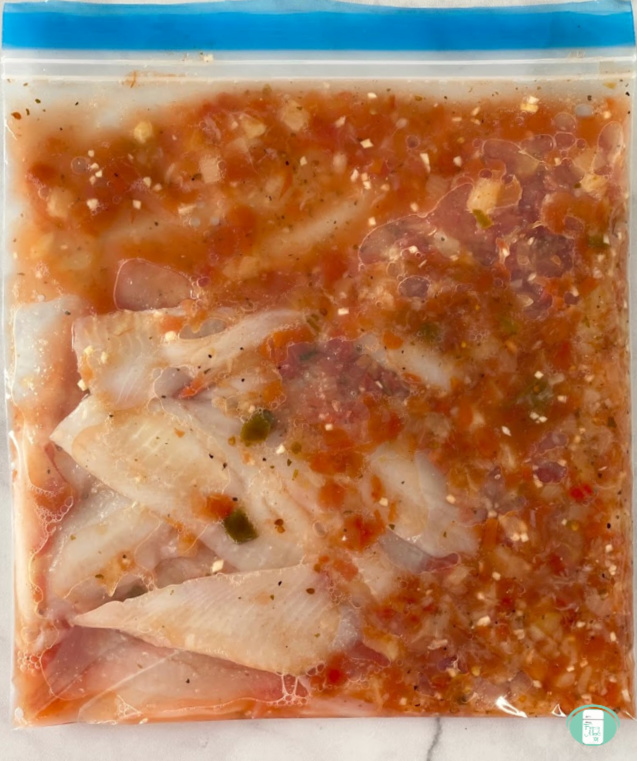 freezer bag with salsa fish taco ingredients inside
