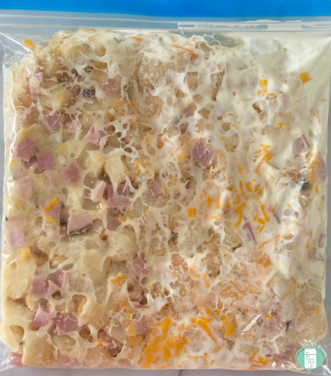 close up of freezer bag with ham and potato casserole 