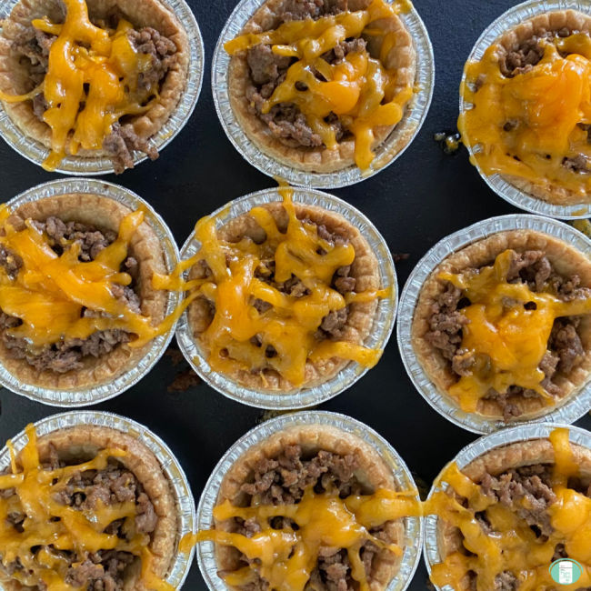 small meat tarts topped with melted cheese