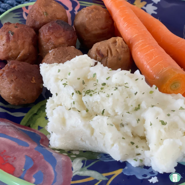 colourful plate of mashed potatoes, carrots, and meatballs