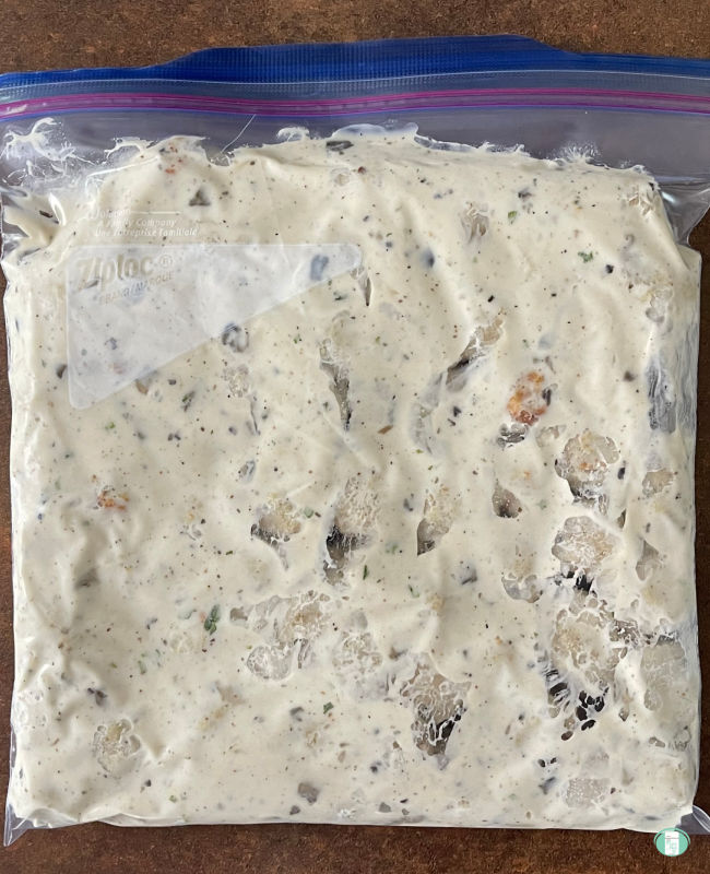 meatballs in a white sauce in a freezer bag