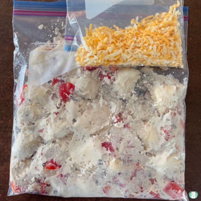 bag of perogies and sauce and smaller bag of shredded cheese