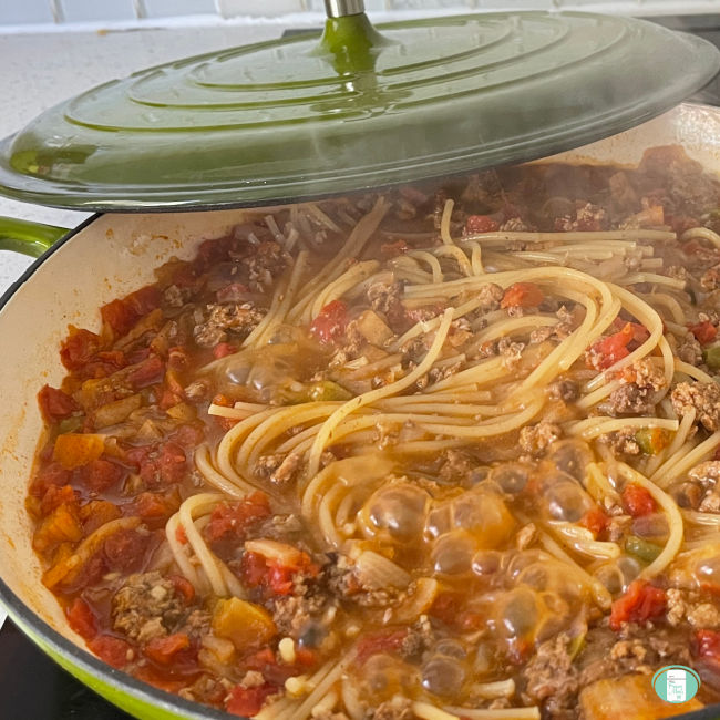 large skillet with spaghetti noodles and sauce