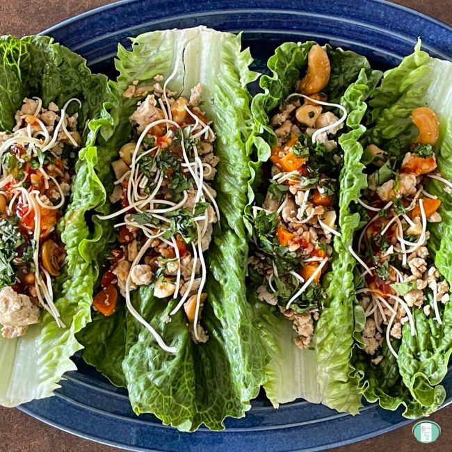 lettuce boats with crispy noodles, vegetables, and ground chicken