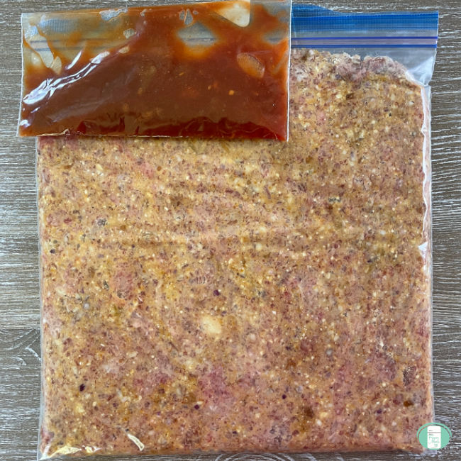 ground beef mixture in a bag with a smaller bag of BBQ sauce on top