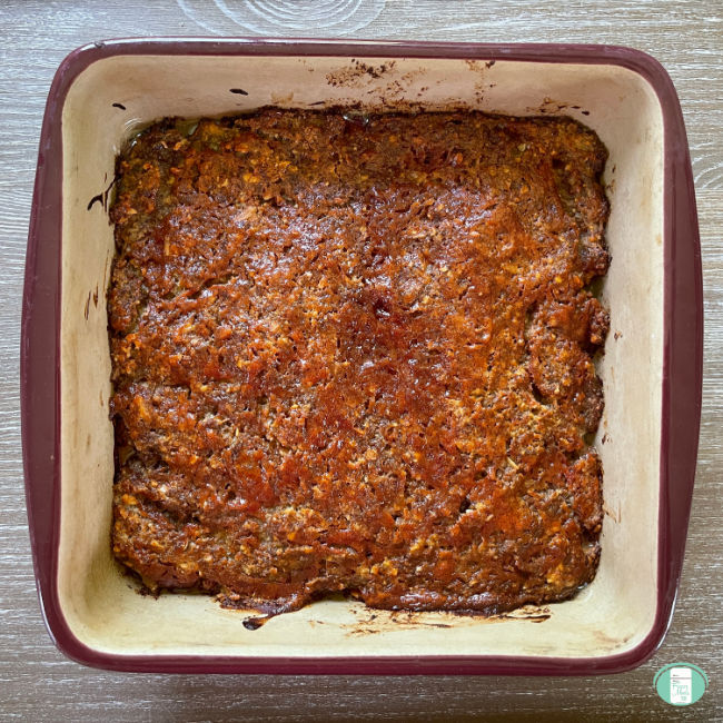 square baking dish with cooked meatloaf in it