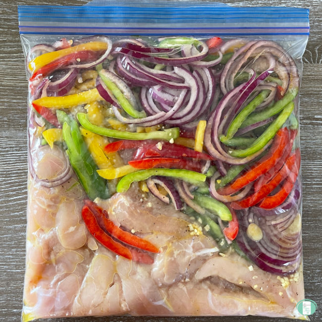 clear bag with chicken and bright vegetables