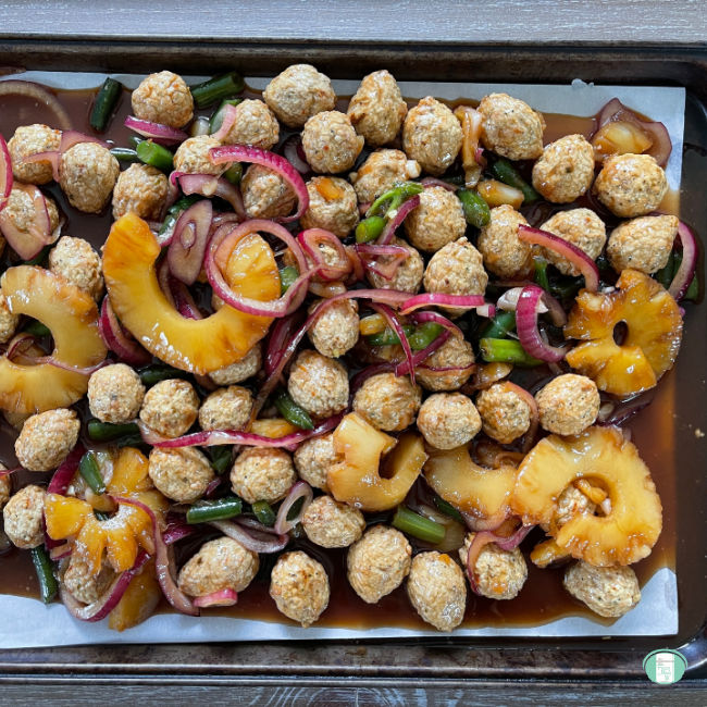 sheet pan with meatballs, pineapple rings, and green beans