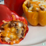 red bell pepper on its side stuffed with ground beef and shredded cheese