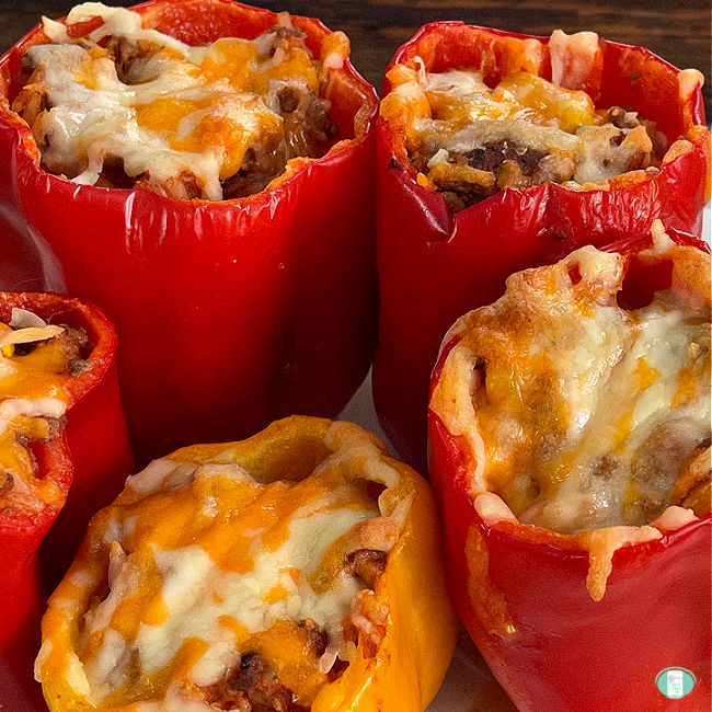 red and yellow peppers stuffed and topped with cheese