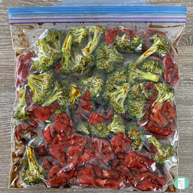 clear bag with broccoli and strips of beef in it