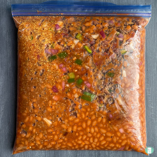 clear bag with a beans mixture in sauce in it