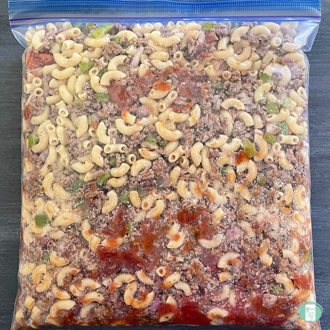 clear bag with macaroni, ground beef, and tomatoes in it