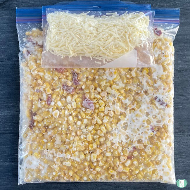 clear bag with corn and bacon and a smaller bag with shredded cheese