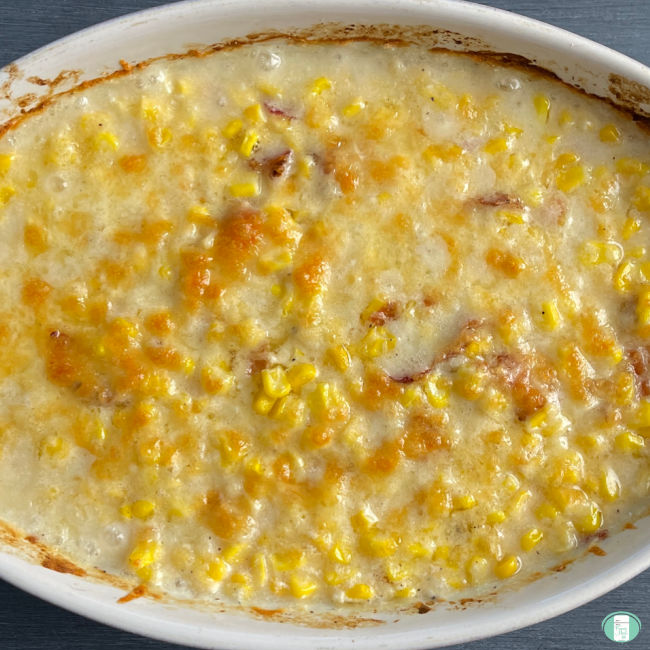 baked cream corn in a white casserole dish