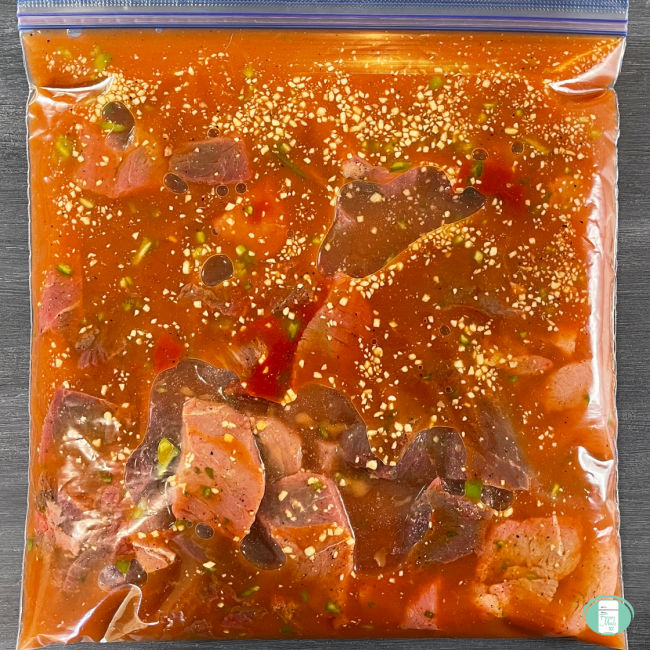 clear bag with meat cubes and sauce