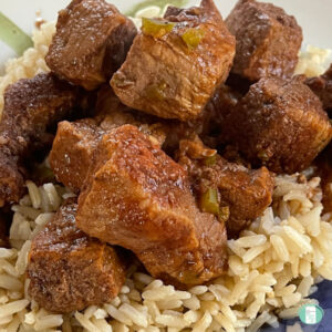 beef stew cubes on top of rice