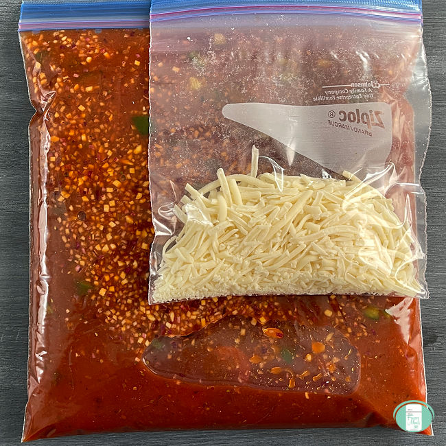 clear bag with red sauce in it and another bag with shredded white cheese in it