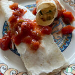 flour tortilla rolls topped with salsa