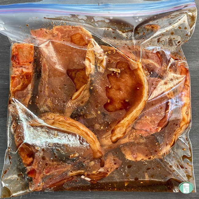 pork chops in sauce in clear plastic bag