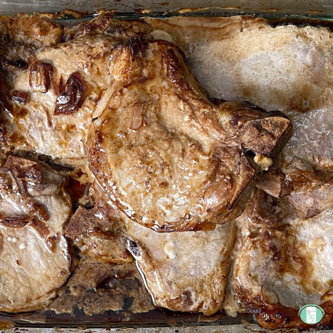 pork chops browned and in baking tray