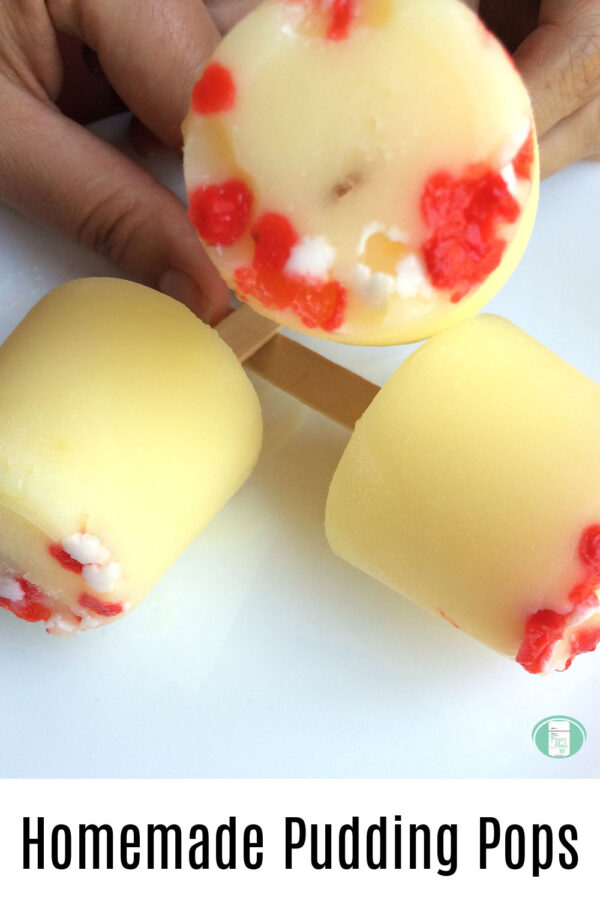 yellow frozen pudding with red and white sprinkles on popsicle sticks