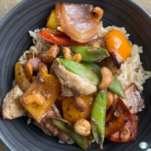 bowl of chunks of chicken and vegetables on rice