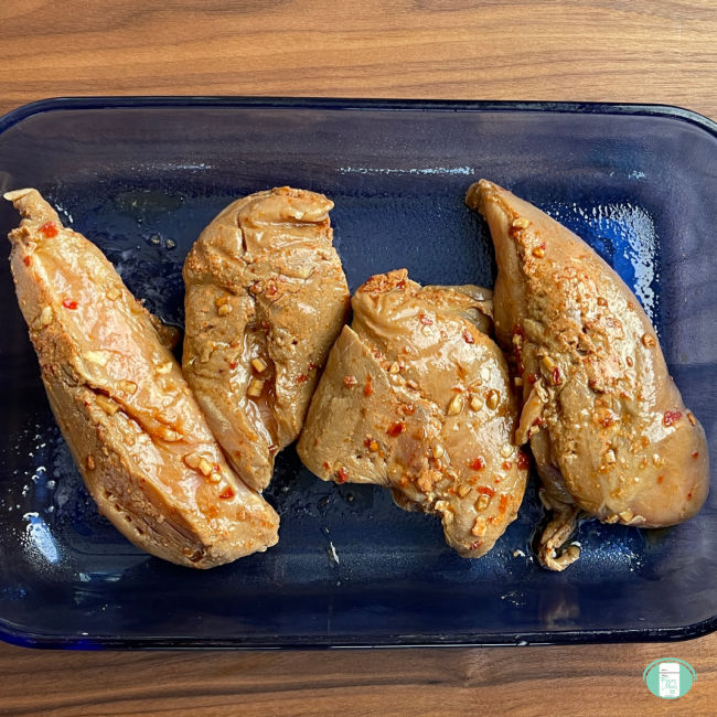 4 chicken breasts on a rectangle plate