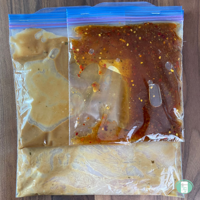 clear bag with raw chicken strips and sauce