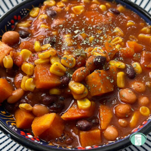 bowl of beans, corn, and cubed sweet potato in sauce