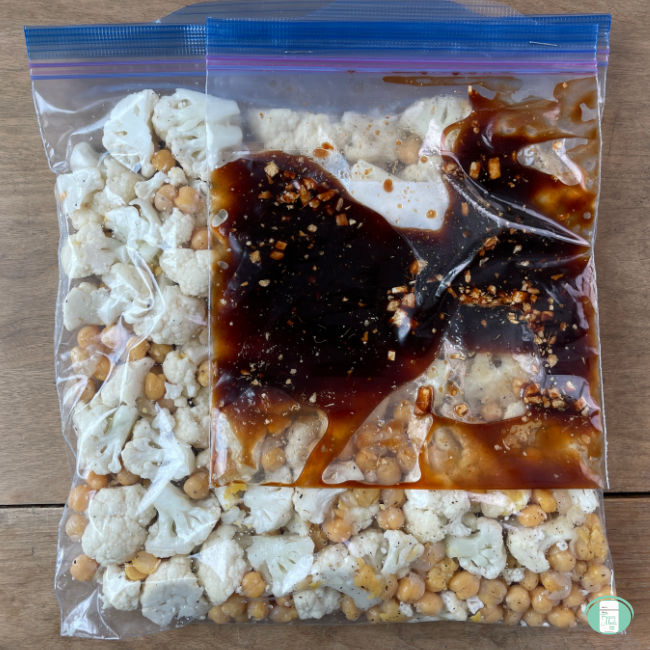clear bag with raw cauliflower florets and a smaller bag of sauce