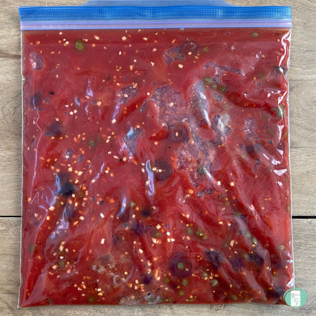 clear bag with red sauce and black olives