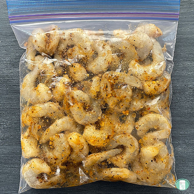 raw seasoned shrimp in a clear bag