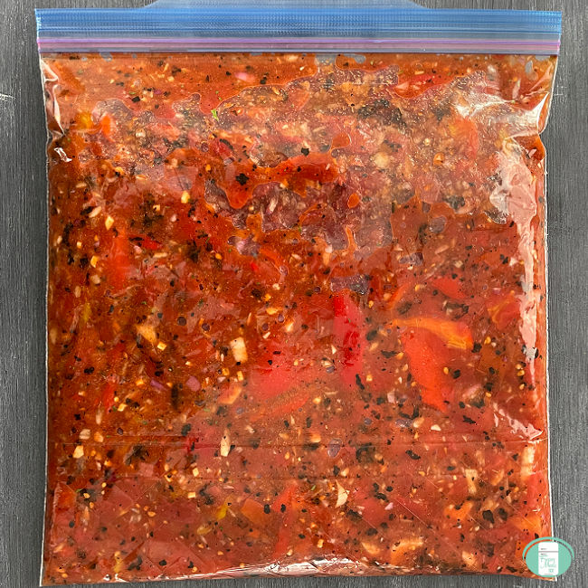 clear bag filled with chunky red sauce