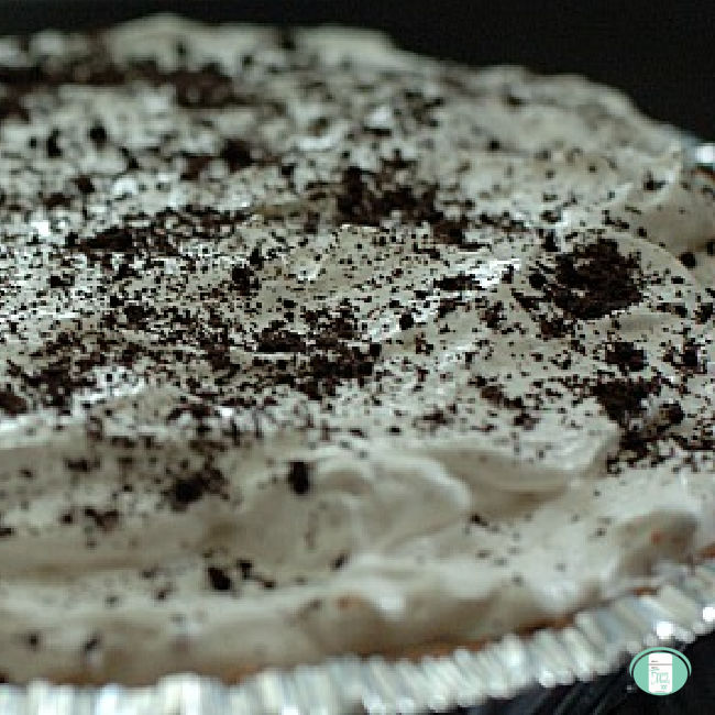 foil pie plate filled with white ice cream topped with chocolate cookie crumbs