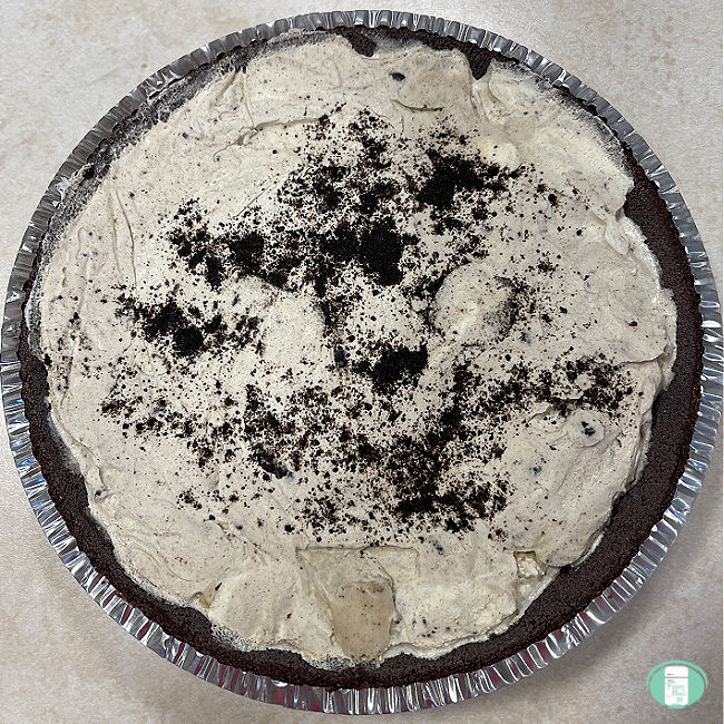 white ice cream in a chocolate crust pie sprinkled with chocolate crumbs